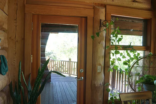 a room with pool table and windows