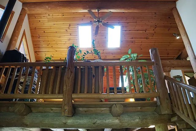 a view of a livingroom with wooden floor and a fireplace