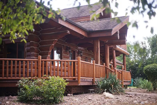 a view of a house with a yard and sitting area