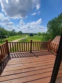 3526 East 2179th Road Ottawa, IL 61350 - Photo 32 of 58 a view of a wooden deck with a bench