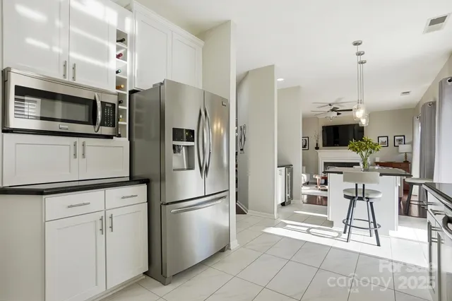a living room with furniture a flat screen tv and a floor to ceiling window