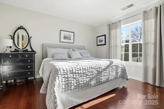 a large bed sitting in a bedroom and a table