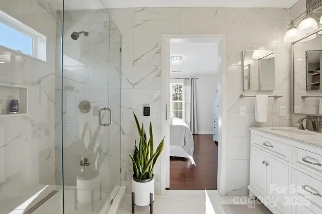 a bathroom with double vanity sink and mirror