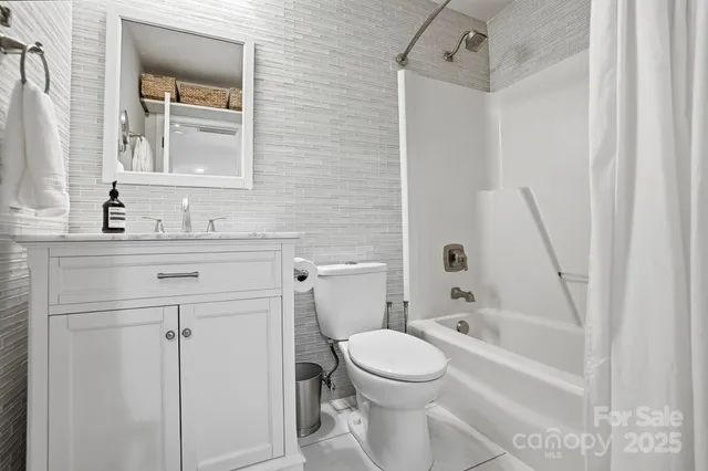 a bedroom with a bed a desk and chair with wooden floor