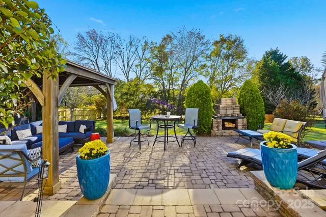 a view of a patio with a table and chairs under an umbrella