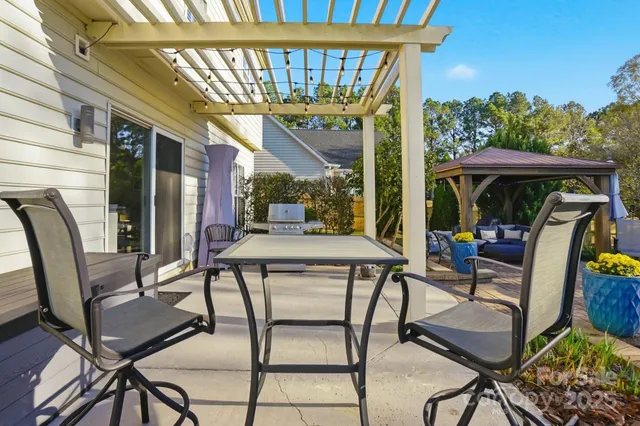 an aerial view of house with yard and outdoor seating