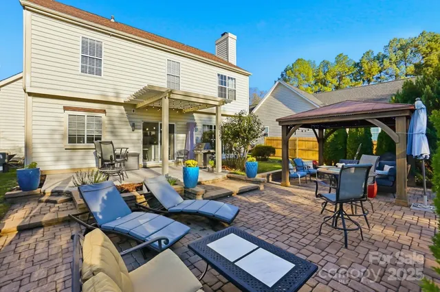 an aerial view of residential houses with outdoor space and trees