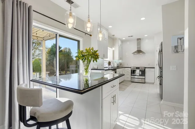 a kitchen with stainless steel appliances a stove a sink and a refrigerator