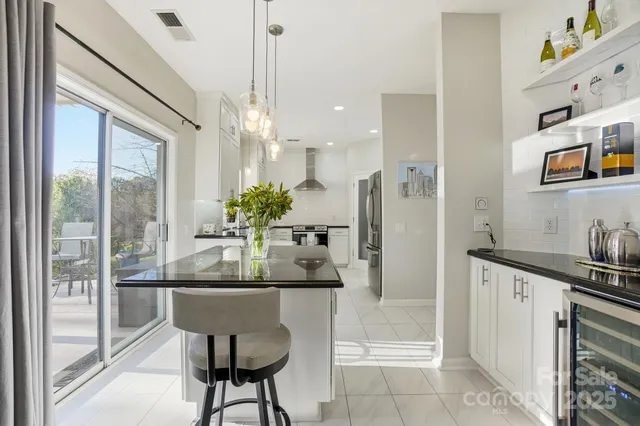 a kitchen with stainless steel appliances granite countertop a stove a sink and a refrigerator