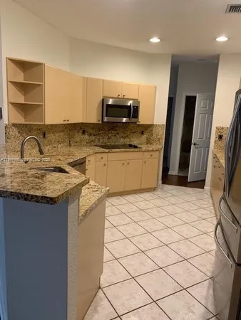 a view of a refrigerator in kitchen and a refrigerator
