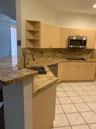 a kitchen with stainless steel appliances a refrigerator sink and cabinets