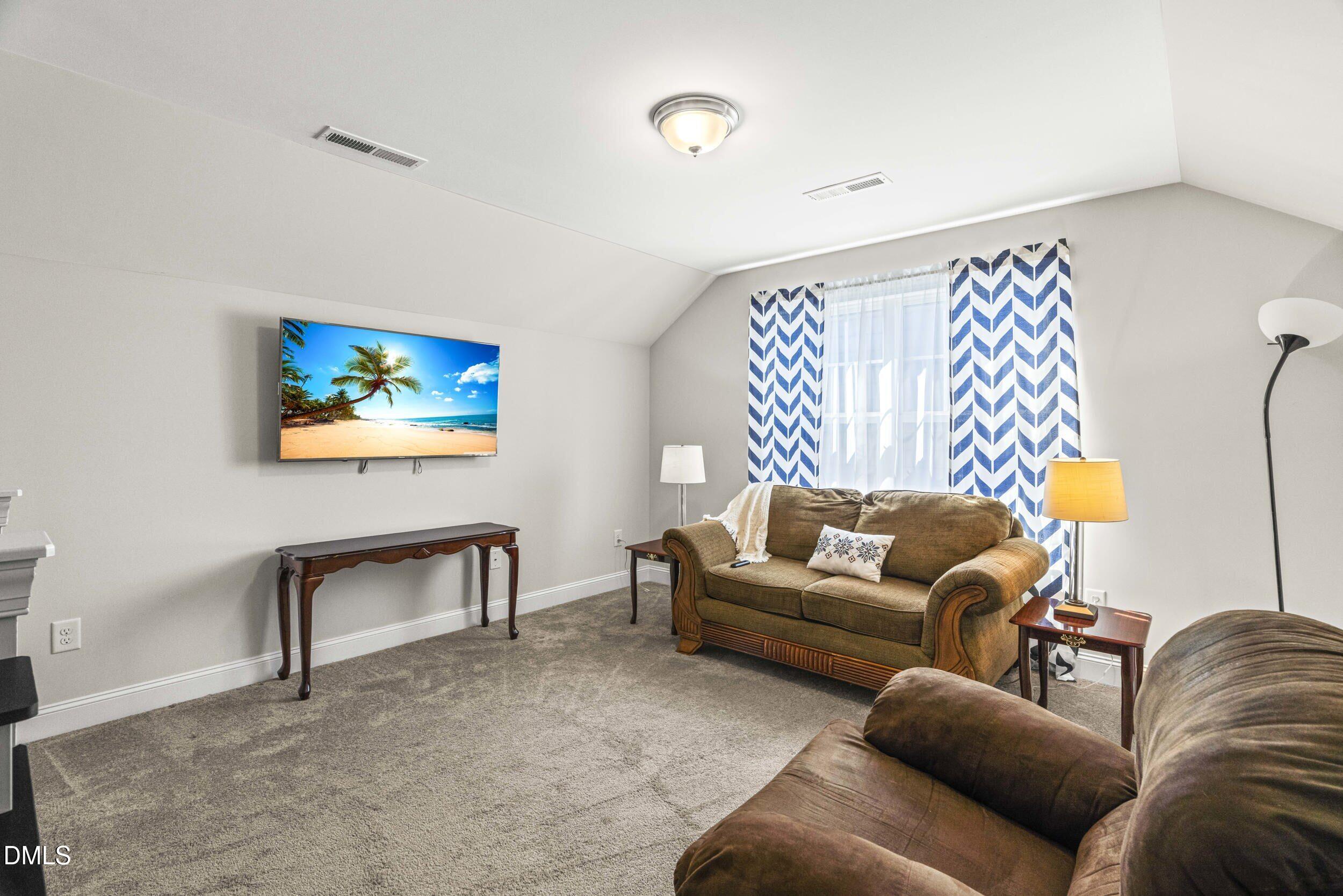 552 Rowanwood Way Apex, NC 27523 - Photo 22 of 30 a living room with furniture and a couch