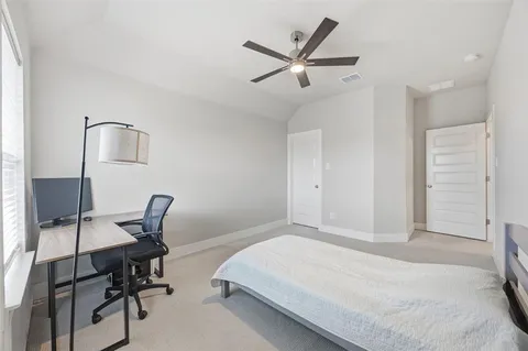 a bedroom with a bed and a chair