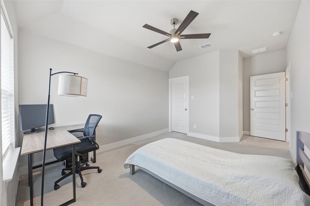 5805 Heatherwood Loop Sachse, TX 75048 - Photo 37 of 39 a bedroom with a bed and a chair