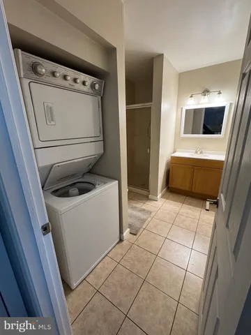a living room with furniture a flat screen tv and a window
