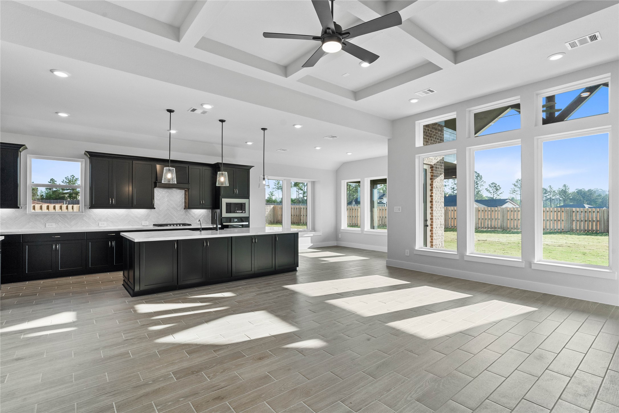 2114 Rowl Street Montgomery, TX 77316 - Photo 22 of 50 Bright, open-concept living designed for both everyday comfort and effortless entertaining. This expansive space features soaring ceilings, abundant natural light, and seamless flow between the kitchen, dining and living areas.
