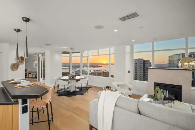 a living room with furniture fireplace and a large window
