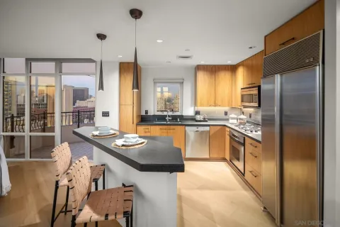 a kitchen with stainless steel appliances granite countertop a sink a stove and a refrigerator