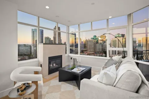 a living room with furniture a large window and a fireplace