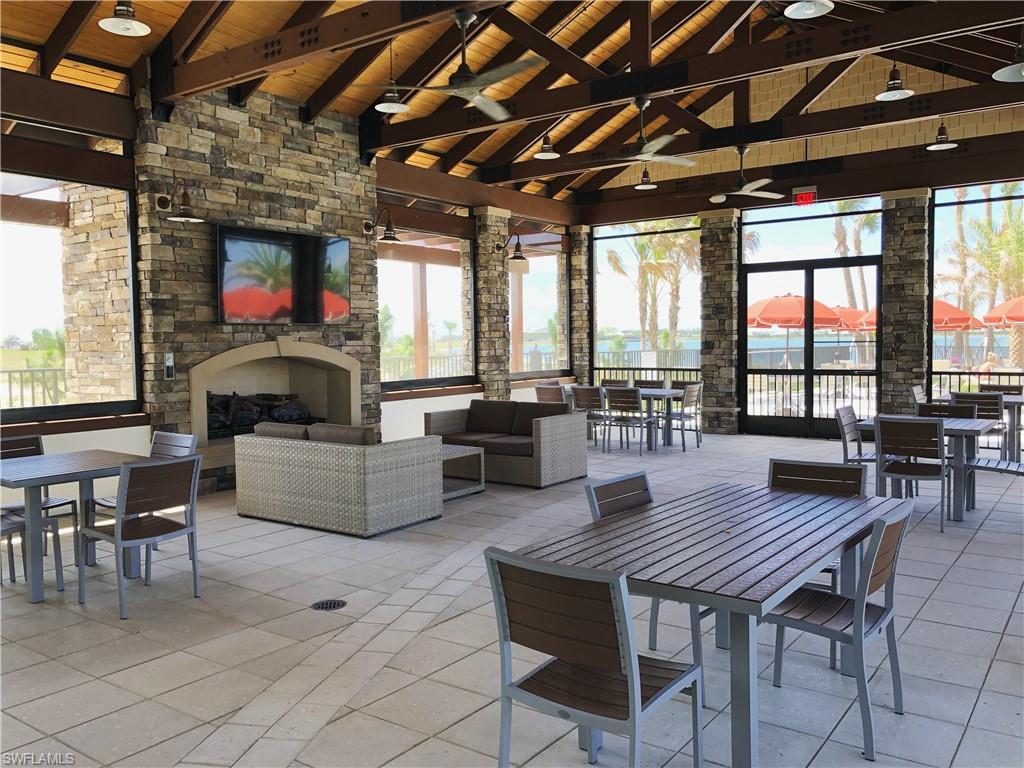 43031 Greenway Boulevard, Unit 1014 Babcock Ranch, FL 33982 - Photo 17 of 19 a living room with furniture wooden floor and a table