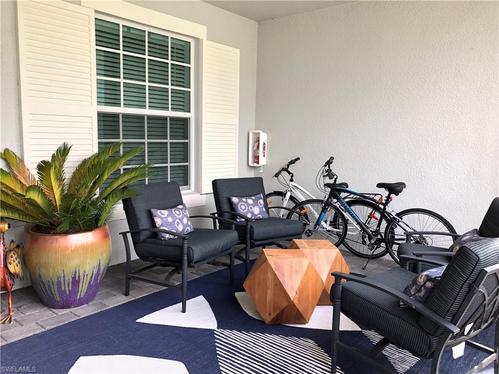 43031 Greenway Boulevard, Unit 1014 Babcock Ranch, FL 33982 - Photo 6 of 19 a living room with furniture a window and potted plants