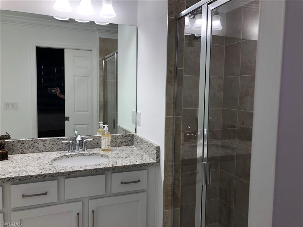 43031 Greenway Boulevard, Unit 1014 Babcock Ranch, FL 33982 - Photo 9 of 19 a bathroom with a granite countertop sink and a mirror