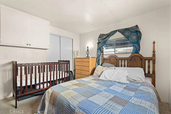 a bedroom with a bed and a window