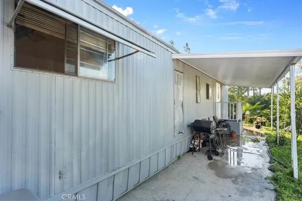 a view of a house with pool and chairs
