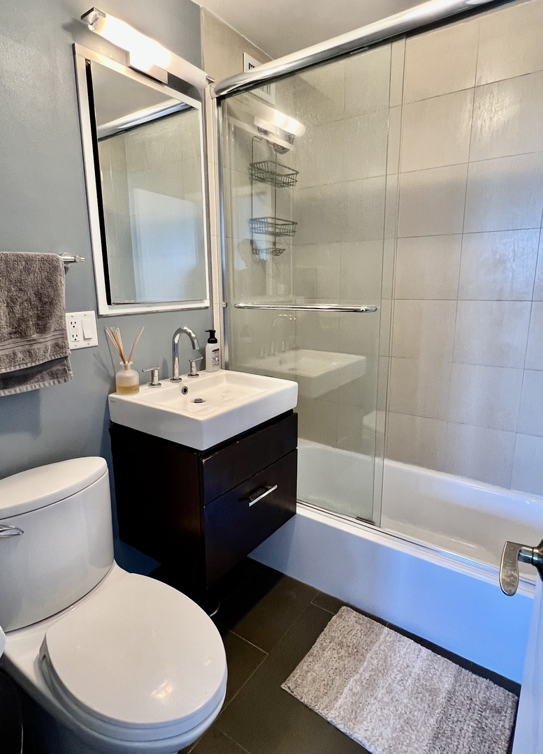 2930 North Sheridan Road, Unit 2006 Chicago, IL 60657 - Photo 3 of 3 a bathroom with a sink a toilet and shower
