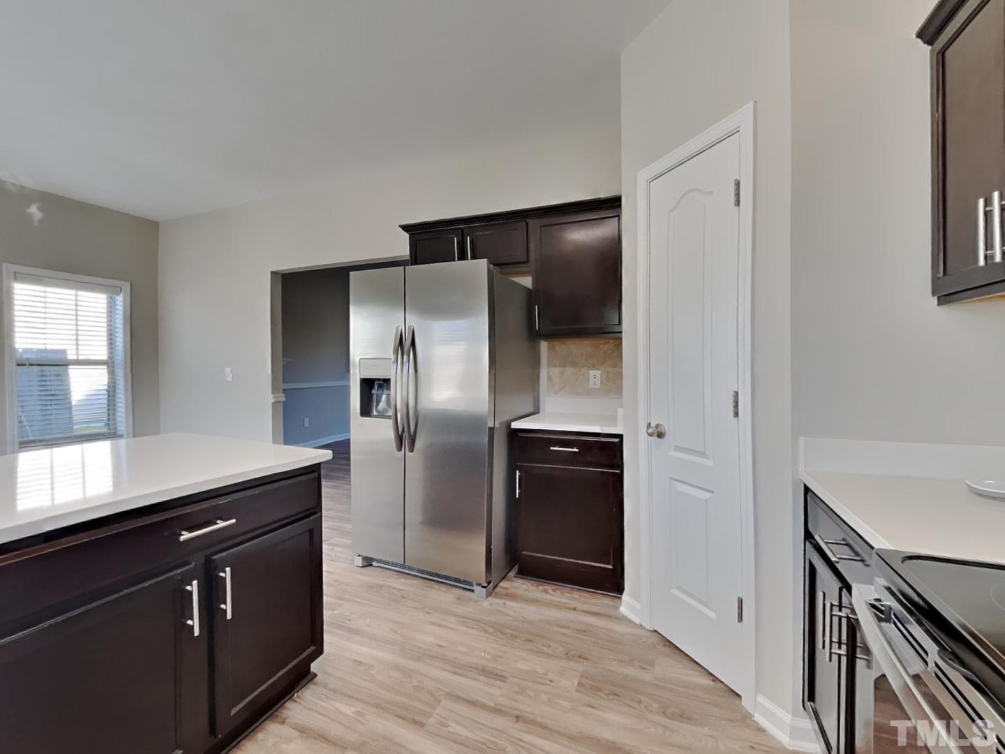 180 Crane Way Bunnlevel, NC 28323 - Photo 11 of 18 a kitchen with granite countertop a refrigerator and a sink