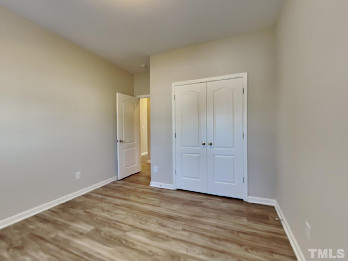 180 Crane Way Bunnlevel, NC 28323 - Photo 12 of 18 a view of an empty room and wooden floor