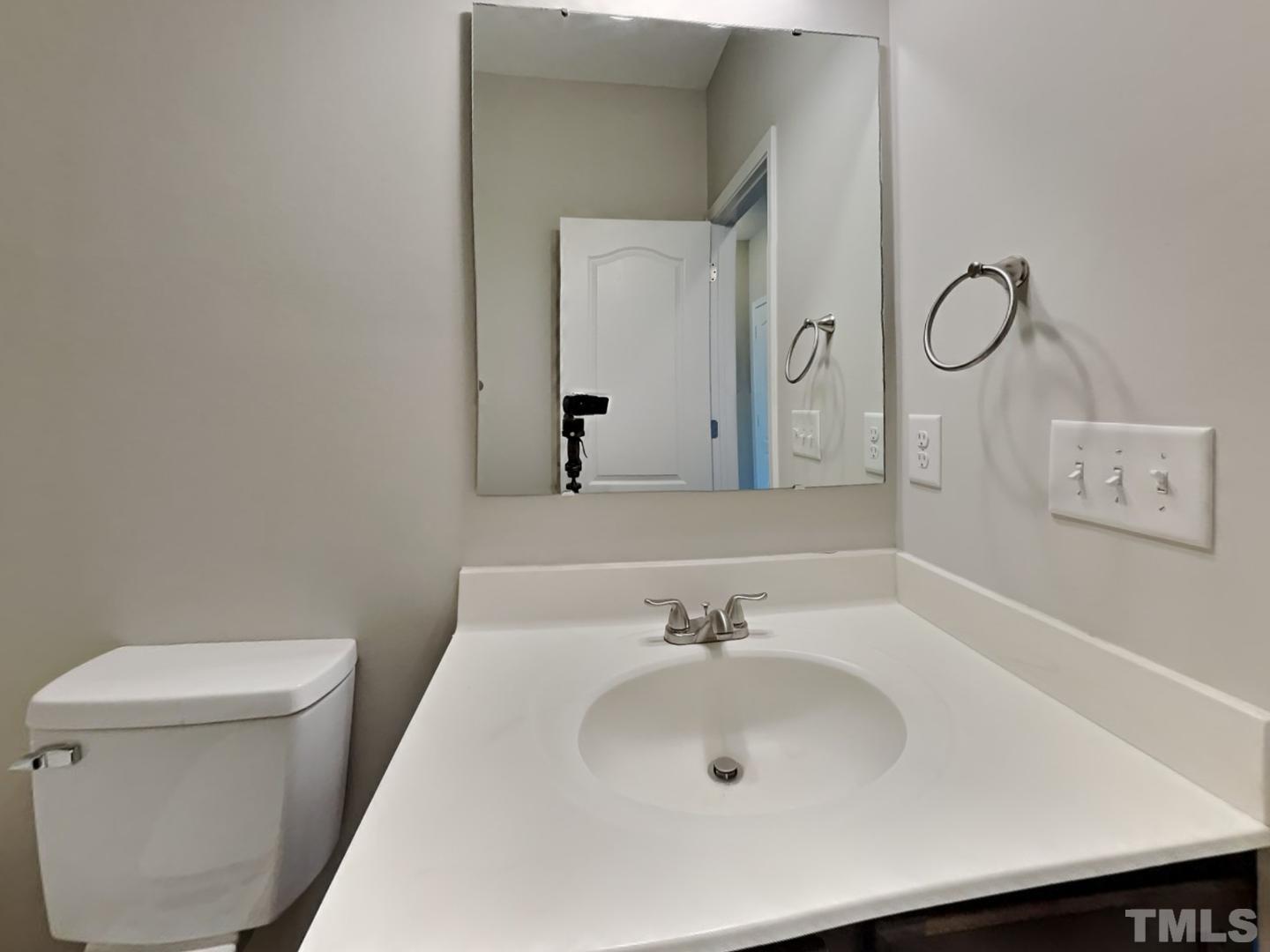 180 Crane Way Bunnlevel, NC 28323 - Photo 17 of 18 a bathroom with a sink and a mirror