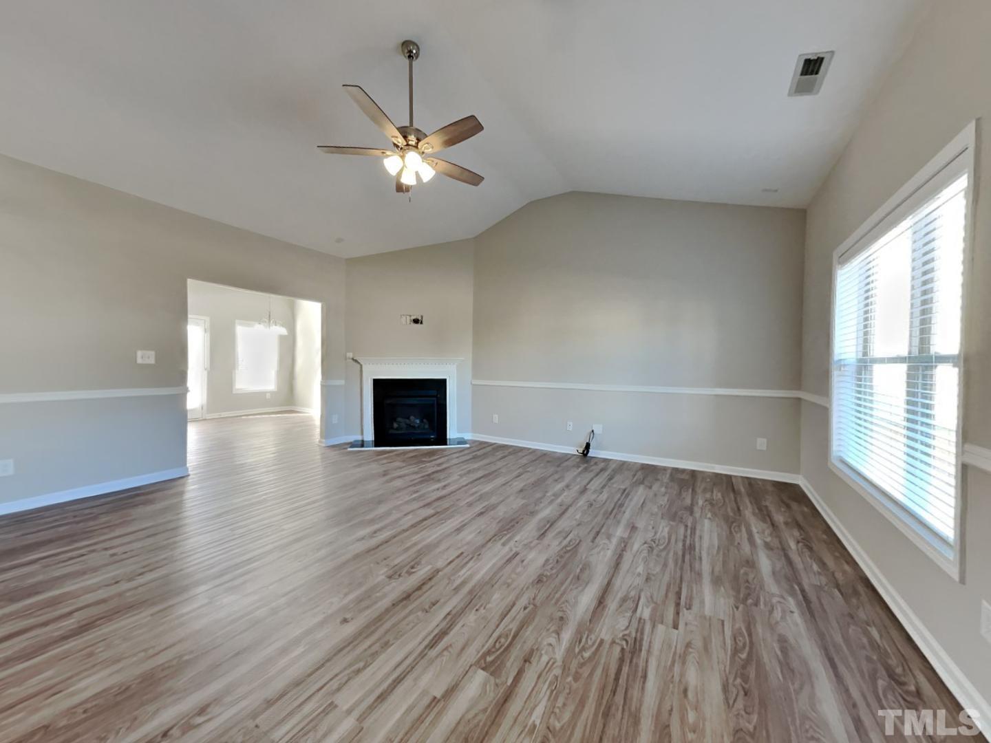 180 Crane Way Bunnlevel, NC 28323 - Photo 2 of 18 wooden floor in an empty room with a window