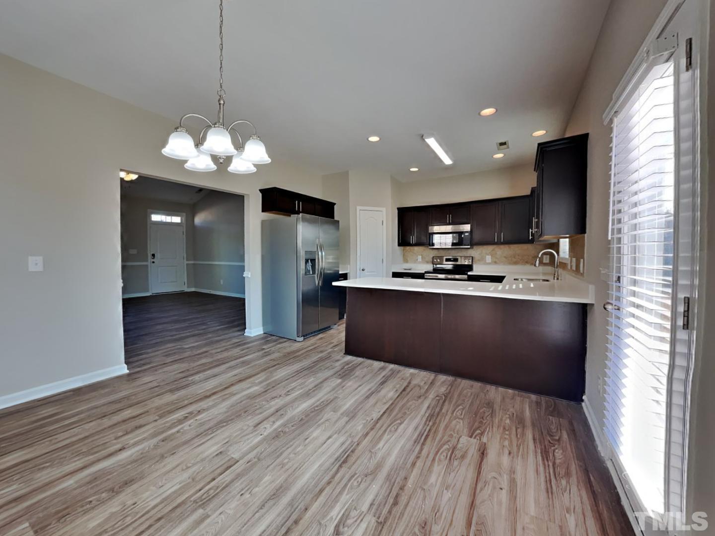 180 Crane Way Bunnlevel, NC 28323 - Photo 4 of 18 a view of kitchen with stainless steel appliances granite countertop counter space a sink refrigerator and microwave