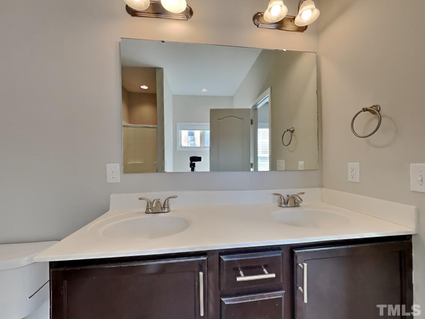 180 Crane Way Bunnlevel, NC 28323 - Photo 8 of 18 a bathroom with a sink and a mirror