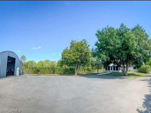 3790 35th Avenue Northeast Naples, FL 34120 - Photo 11 of 27 a view of a road with a building in the background