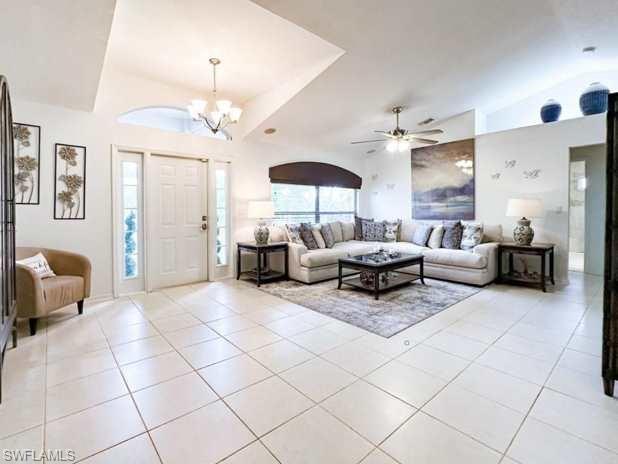 3790 35th Avenue Northeast Naples, FL 34120 - Photo 20 of 27 a living room with furniture and a chandelier