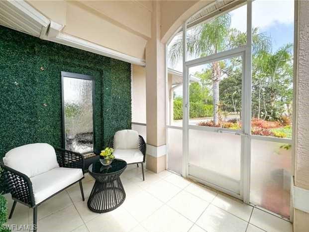 3790 35th Avenue Northeast Naples, FL 34120 - Photo 2 of 27 a living room with furniture and a window