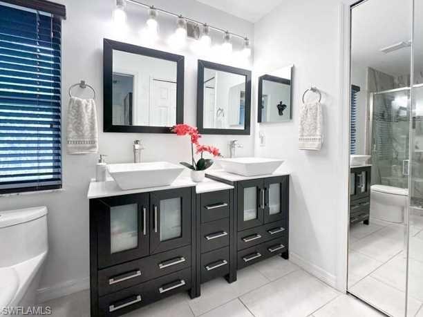 3790 35th Avenue Northeast Naples, FL 34120 - Photo 26 of 27 a bathroom with a sink and a mirror