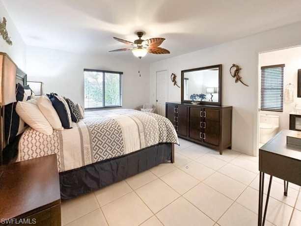 3790 35th Avenue Northeast Naples, FL 34120 - Photo 27 of 27 a bedroom with a bed and a chandelier