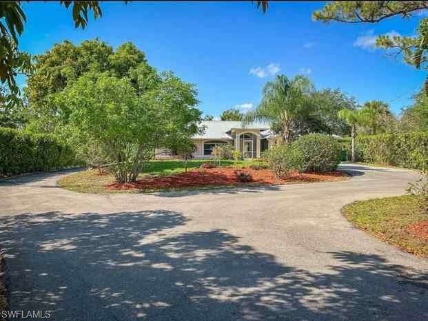 3790 35th Avenue Northeast Naples, FL 34120 - Photo 3 of 27 a car parked on the side of the road