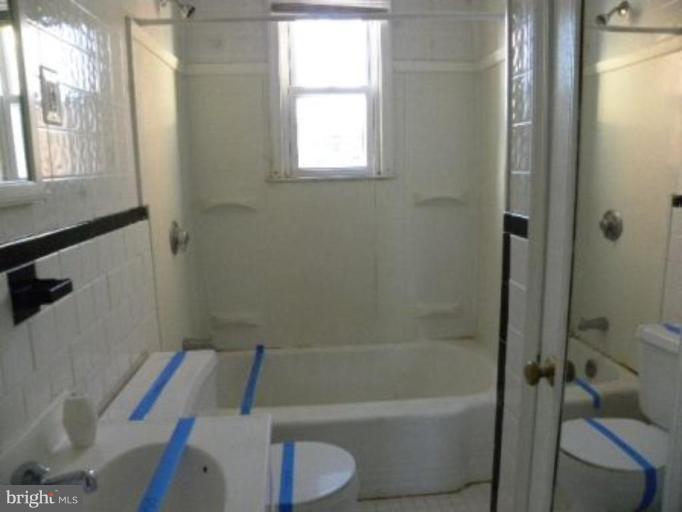 4842 Greencrest Road Baltimore, MD 21206 - Photo 13 of 14 a bathroom with a sink a toilet and shower