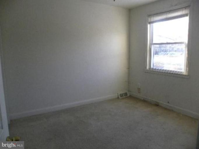4842 Greencrest Road Baltimore, MD 21206 - Photo 14 of 14 an empty room with a window