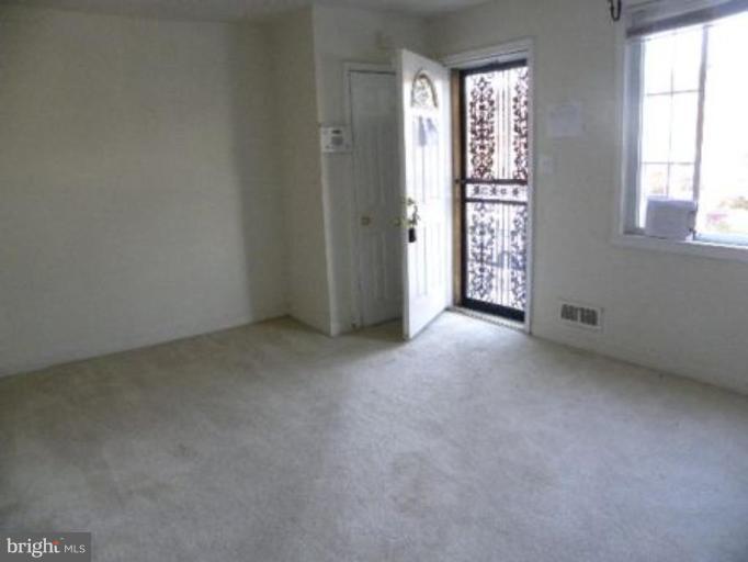 4842 Greencrest Road Baltimore, MD 21206 - Photo 3 of 14 an empty room with windows and closet