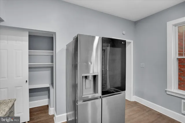 a metallic refrigerator freezer sitting in a kitchen