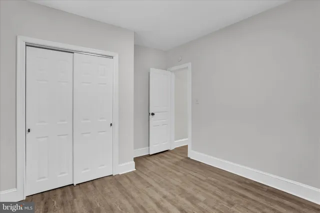 a view of an empty room and wooden floor