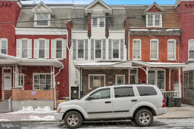 a front view of a residential apartment building with a parking space