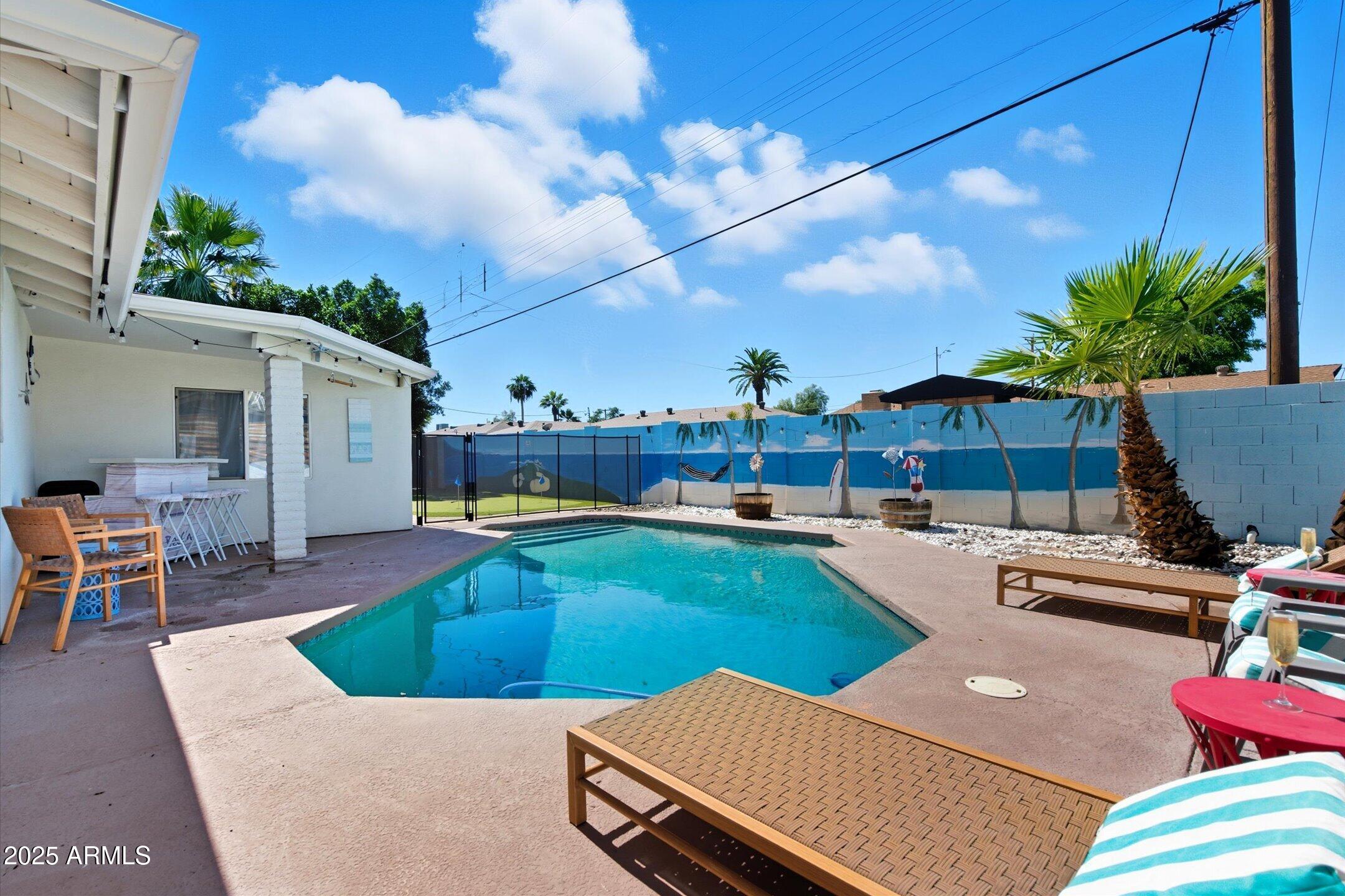 2530 North 68th Place Scottsdale, AZ 85257 - Photo 1 of 52 a view of a backyard with swimming pool and furniture