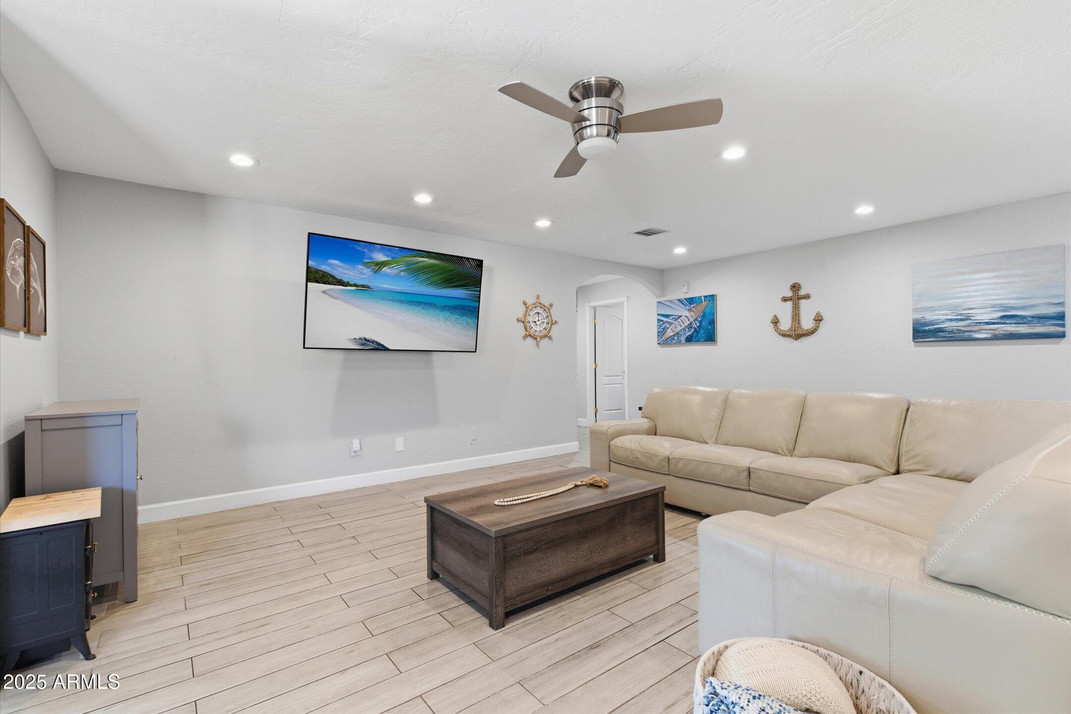 2530 North 68th Place Scottsdale, AZ 85257 - Photo 16 of 52 a living room with furniture and a ceiling fan