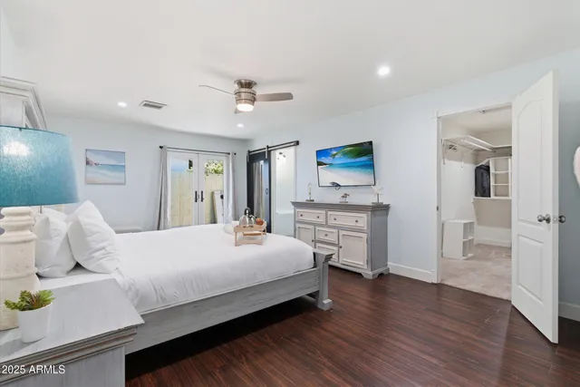 a bed room with a bed and a tv